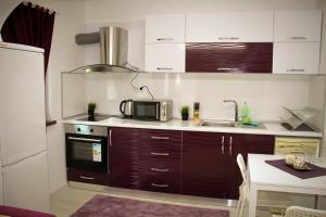 a kitchen with a microwave and a sink at КЪЩА КАРБИ in Kŭrdzhali