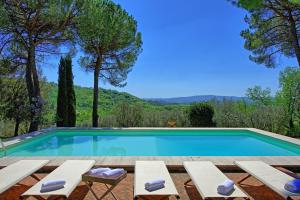 a swimming pool with two lounge chairs and a swimming pool at Villa Orchidea by PosarelliVillas in Certaldo