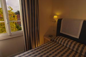 Postel nebo postele na pokoji v ubytování Hotel Arnolfo & Aqua Laetitia Spa & Beauty