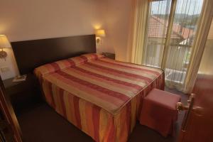 Postel nebo postele na pokoji v ubytování Hotel Arnolfo & Aqua Laetitia Spa & Beauty