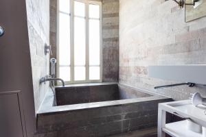 a bath tub in a bathroom with a window at CMG - Suite Premium Tour Eiffel - 71 in Paris