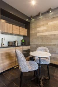 a kitchen with a table and chairs in a kitchen at CMG - Suite Premium Tour Eiffel - 71 in Paris