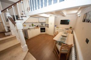 a kitchen with a staircase with a table and chairs at Daniela house in Anzio