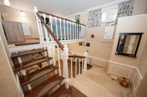 a winding staircase in a home with wooden floors at Daniela house in Anzio