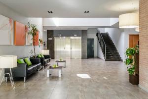 a lobby with couches and tables and a staircase at Crisol La Selva in La Selva del Camp