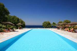 a swimming pool with a view of the ocean at Viva Mare Hotel & Spa in Mythimna