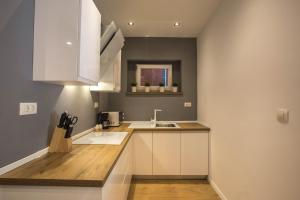 kuchnia z białymi szafkami i zlewem w obiekcie Exclusive city center apartment with garden w Rovinj +36 zdjęć