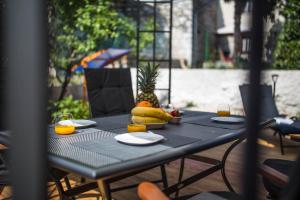 a black table with a bunch of fruit on it at Exclusive city center apartment with garden in Rovinj