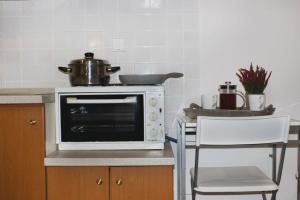 A kitchen or kitchenette at Souzana Rooms