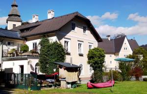 a large white house with a yard in front of it at kajakshop-wildalpen in Wildalpen