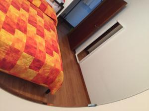 a large bed in a room with a wooden floor at Vecchia Riva in Riva del Garda