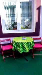 a table and two chairs with a table and a window at Mama Brasov in Braşov