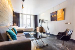 a living room with a couch and a glass table at CMG - Suite Premium Tour Eiffel - 51 in Paris