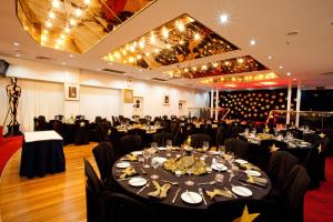 a banquet hall with a table set for a party at Mercure Maitland Monte Pio in Maitland