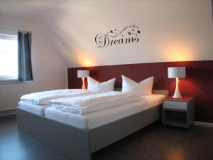 sypialnia z 2 łóżkami i znakiem na ścianie w obiekcie Hotel ELBRIVERA Alt Prester w mieście Magdeburg