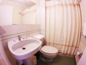 a white bathroom with a sink and a toilet at Hotel San Francisco De la Selva in Copiapó +39 photos