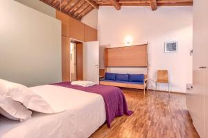 a bedroom with a bed and a bench in a room at Casale del Mare in Castiglioncello