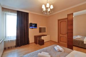 a hotel room with a bed and a chandelier at Serviced Apartment on Rustaveli Avenue in Tbilisi City