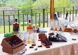 a table with glasses and a bottle of wine on it at Il Casale Della Regina in Arpino