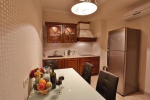 a kitchen with a table with fruit and a refrigerator at Serviced Apartment on Rustaveli Avenue in Tbilisi City