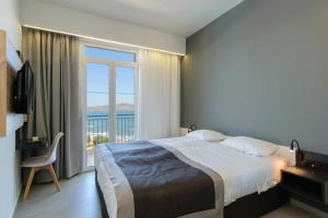 Postel nebo postele na pokoji v ubytování Renieris Hotel