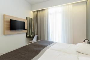 Postel nebo postele na pokoji v ubytování Renieris Hotel