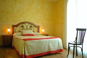 - une chambre avec un lit, deux lampes et une chaise dans l'établissement Hotel Brezales, à Espejón