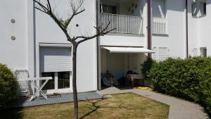 a man sitting in the entry to a white building at condominio vite in Misano Adriatico