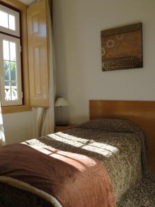 Ліжко або ліжка в номері Alojamento Cesarini