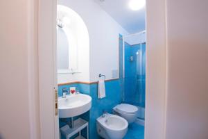 a blue bathroom with a sink and a toilet at La Scivitella in Amalfi +63 photos