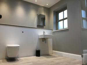 a bathroom with a toilet and a sink at Dunvegan Castle Keepers Cottage in Dunvegan +7 photos