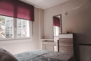 オウレンセにあるPiso centroのベッドルーム1室(ベッド1台、ドレッサー、窓付)