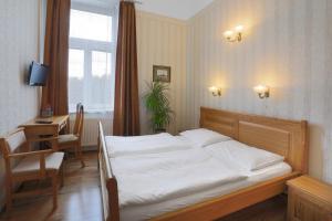 Posteľ alebo postele v izbe v ubytovaní Hotel Štekl - Hrubá Skála