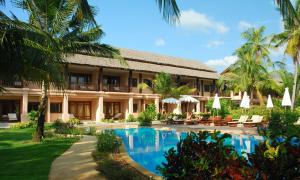 an exterior view of a resort with a swimming pool at Andamania Beach Resort, Khaolak - SHA plus in Khao Lak