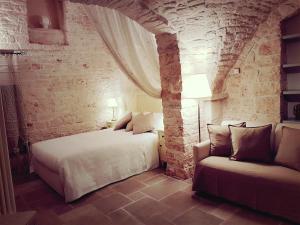 A bed or beds in a room at Trulli D'Angiò