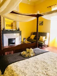 a bedroom with a bed with a tray of food on it at Domaine Mas Pigné in Sauve +78 photos