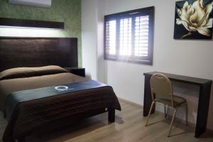 Postel nebo postele na pokoji v ubytování Hotel Onix Suites