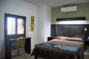 Postel nebo postele na pokoji v ubytování Hotel Onix Suites