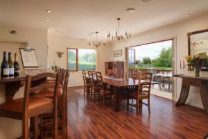 a kitchen and dining room with a table and chairs at Chalet Eiger in Taupo