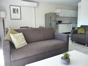 a living room with a couch and a coffee table at Jadran Motel & El Jays Holiday Lodge in Gold Coast