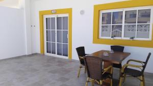 a dining room with a wooden table and chairs at Sonder in Caleta De Fuste