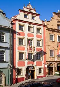 a large red and white building on a city street at Red Lion Hotel in Prague