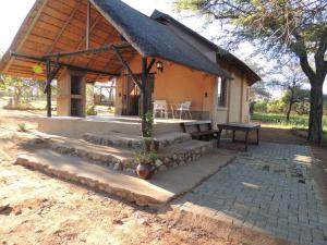 a small house with a potted plant in front of it at Karibu River Retreat in Marble Hall