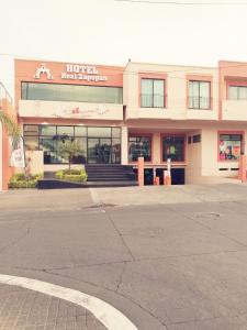 an empty street in front of a motel next to a building at Hotel Real Zapopan in Guadalajara