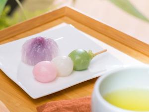 a plate of food with limes and a cup of tea at Vessel Inn Hakata Nakasu in Fukuoka