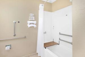 a bathroom with towels on the wall and a shower at Microtel Inn and Suites Clear Lake in Clear Lake