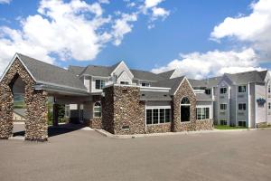 a large white house with a large driveway at Microtel Inn & Suites by Wyndham Bozeman in Bozeman