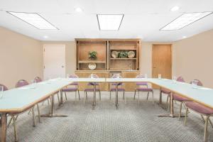 a conference room with a long table and chairs at Hawthorn Extended Stay Hotel by Wyndham-Green Bay in Green Bay