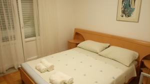 Postel nebo postele na pokoji v ubytování Apartments Gaston