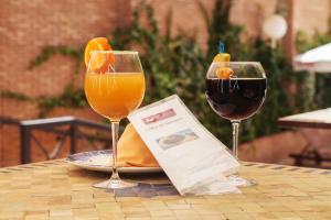 two glasses of wine and a piece of paper on a table at Bellavista Sevilla in Seville